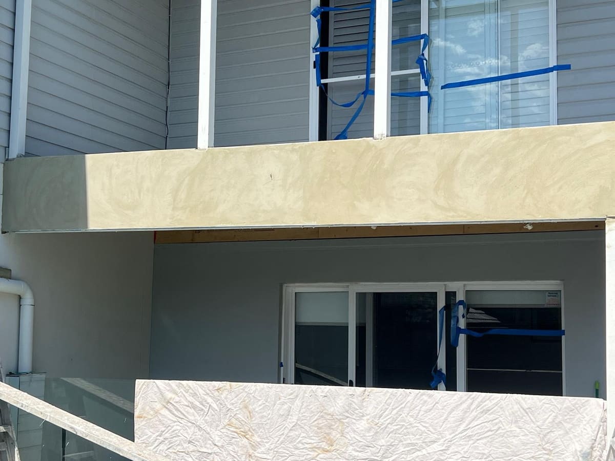 Freshly rendered balcony bulkhead on a Sydney home being prepared for a texture finish