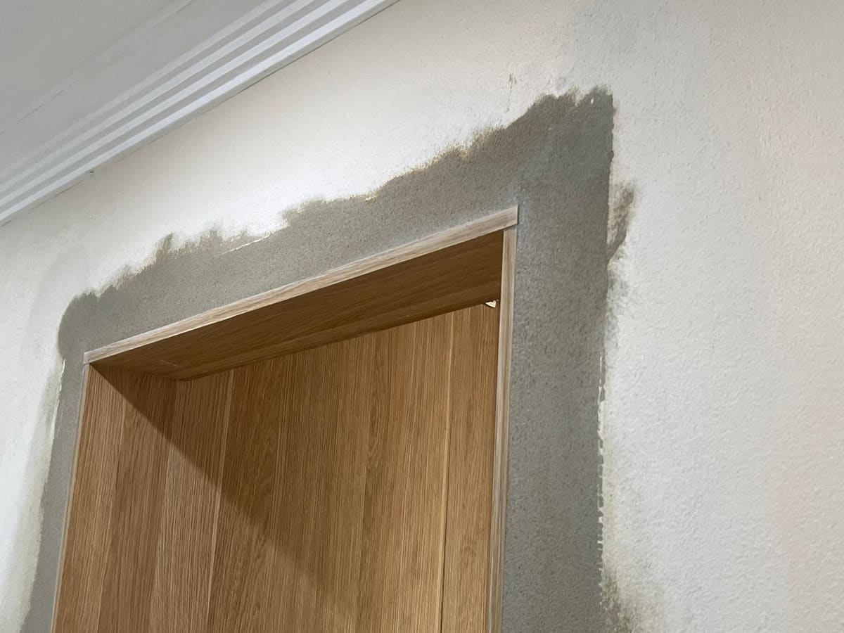 Fresh render patch around an interior doorway in a Sydney home blended into the existing textured wall