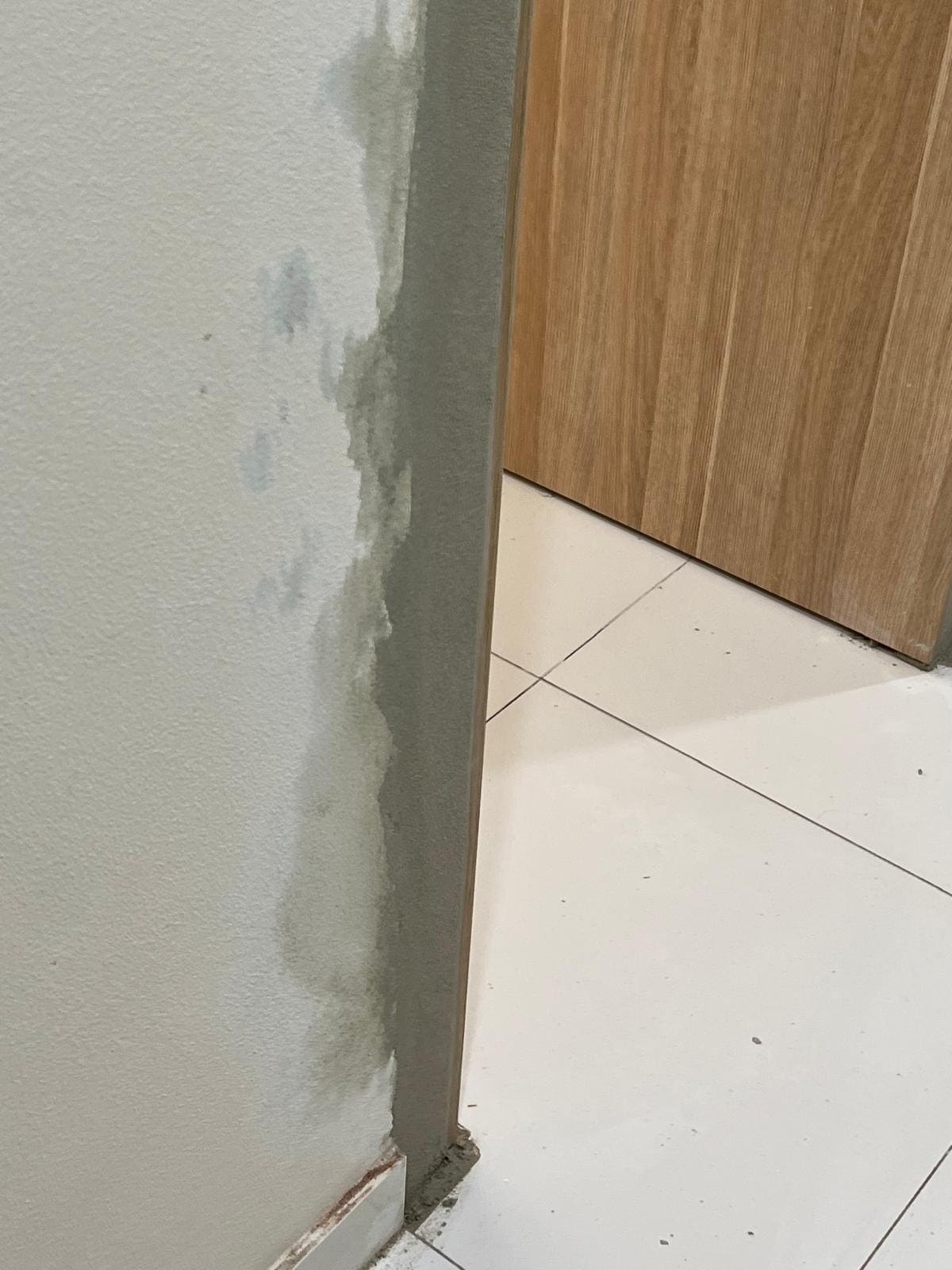 Interior wall render repair beside a timber door frame in a Sydney home