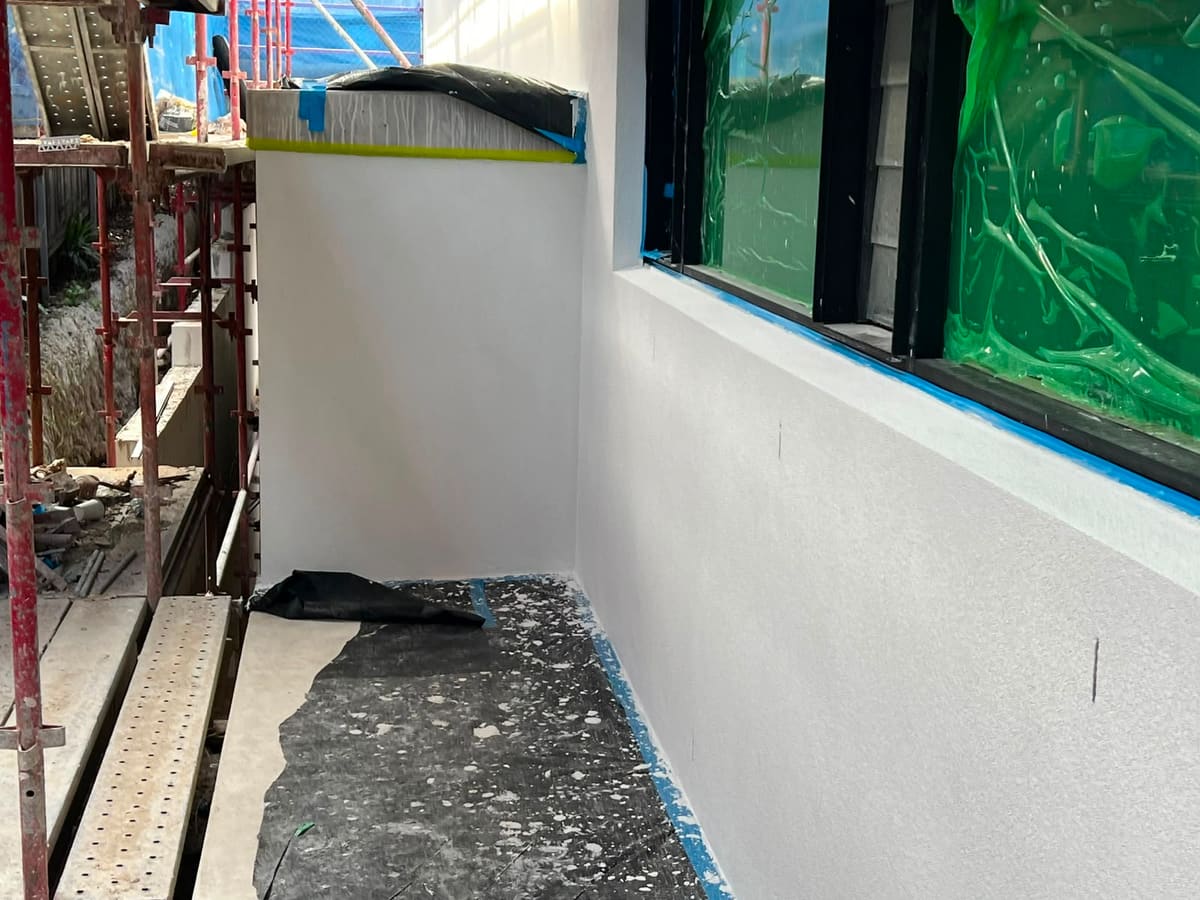 Rendered balcony parapet wall on a Sydney home with the top edge capped and taped ready for finishing