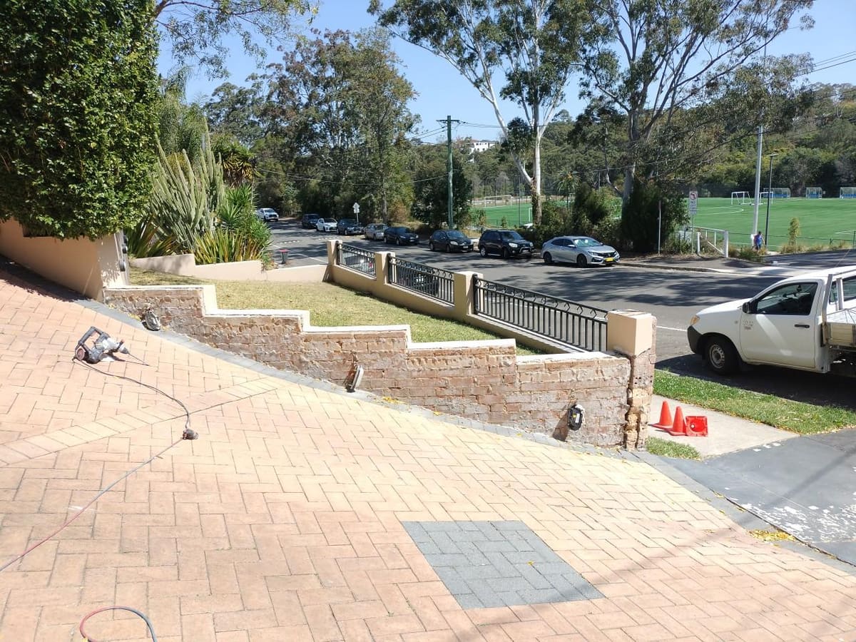 Sandstone and brick retaining wall on a Sydney street being prepared for rendering by SPR Rendering