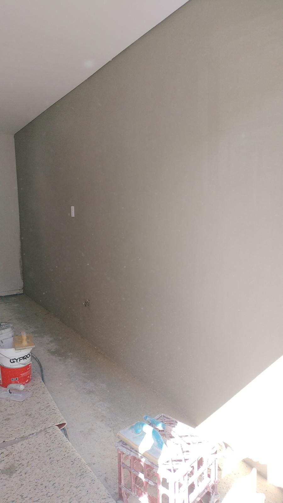 Interior feature wall in a Sydney home finished in smooth grey cement render