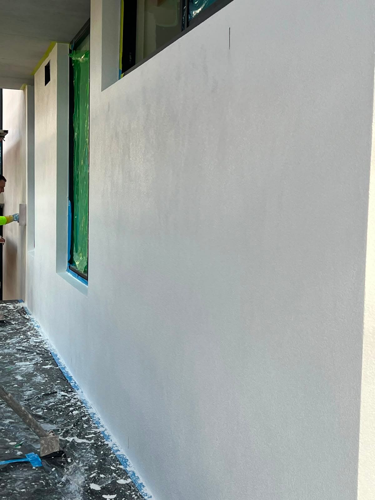 Smooth white rendered wall on a Sydney new build with the render freshly floated and finished