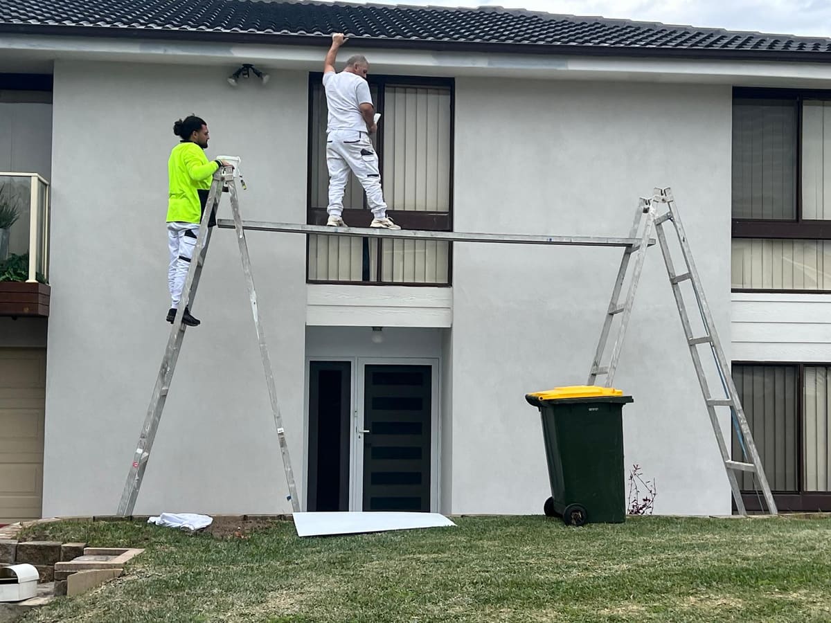 SPR Rendering tradesmen on ladders and a work plank rendering the front of a Sydney house