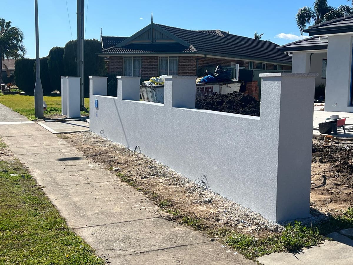 White textured render on a front fence and piers at a newly built Sydney home